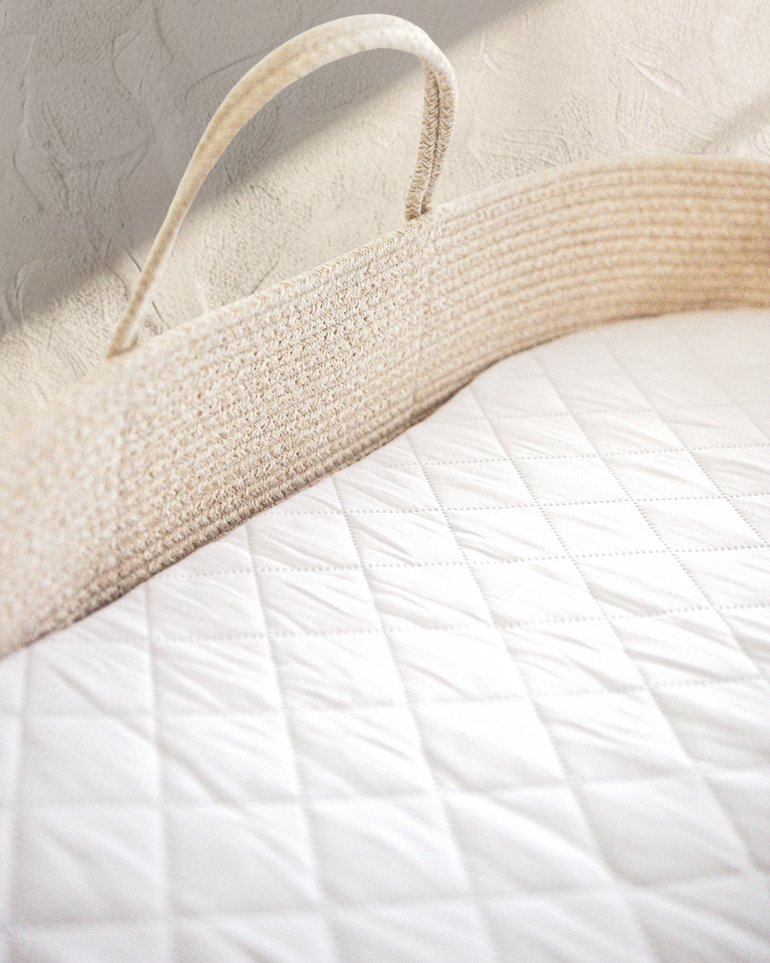 Beige cotton rope moses basket close-up of handle